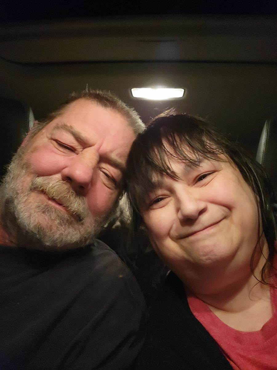 Smiling couple lean together