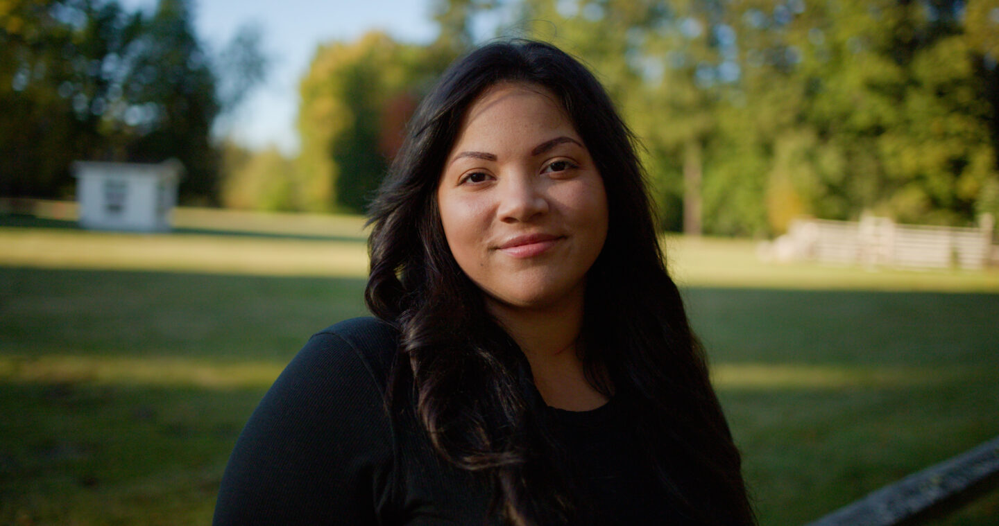 Jasmine in beautiful natural light with out-of-focus field behind her
