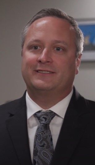 Formal portrait of Scott in suit and tie