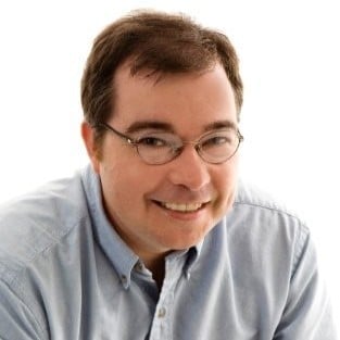 David smiling up against a solid white background