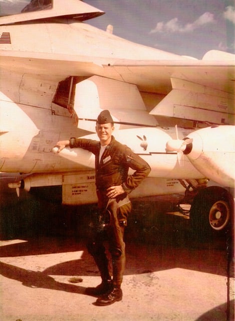 Sepia-tinted photo of man in flight cap