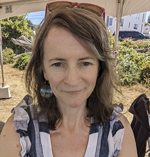 Selfie style portrait of Catherine West in tent on a sunny day