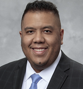 Professional headshot of Daniel Hsieh in blue tie