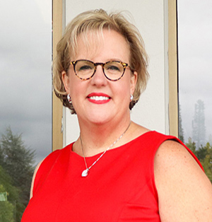 Toni Hood portrait in front of mirrored windows